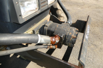 Front view of a 1996 Ford 6640 tractor hitch area showing hydraulic hoses, coupling, and PTO shaft connection.