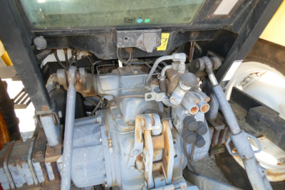 Ford 6640 tractor engine bay showing hydraulic pumps and engine components.