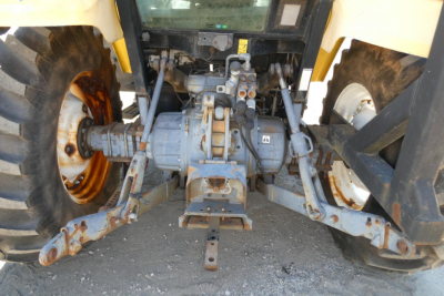 Tractor rear hitch and differential housing with hydraulics and PTO from a Ford 6640, showing PTO drive shaft, hydraulic lines, and rugged tires.