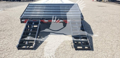Beavertail trailer ramped loading deck with metal slats and dual loading ramps visible.
