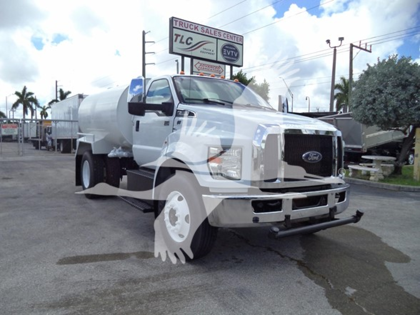 2017 Ford F650 from front/side view showing fuel/water tanker in chassis with front grille, Ford emblem, large side mirrors, and tanker body.