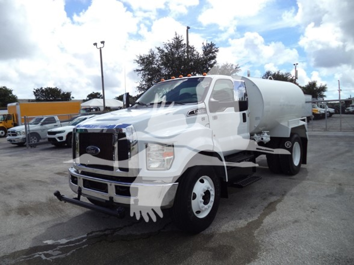 Ford F650 heavy-duty truck with tank body showing front grille, bumper, and water tank on chassis.
