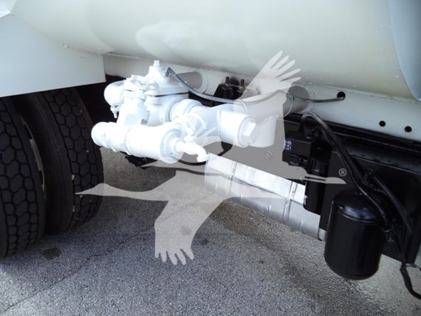 Truck rear undercarriage showing hydraulic line assembly and cylindrical filter housing near chassis on a Ford F650.