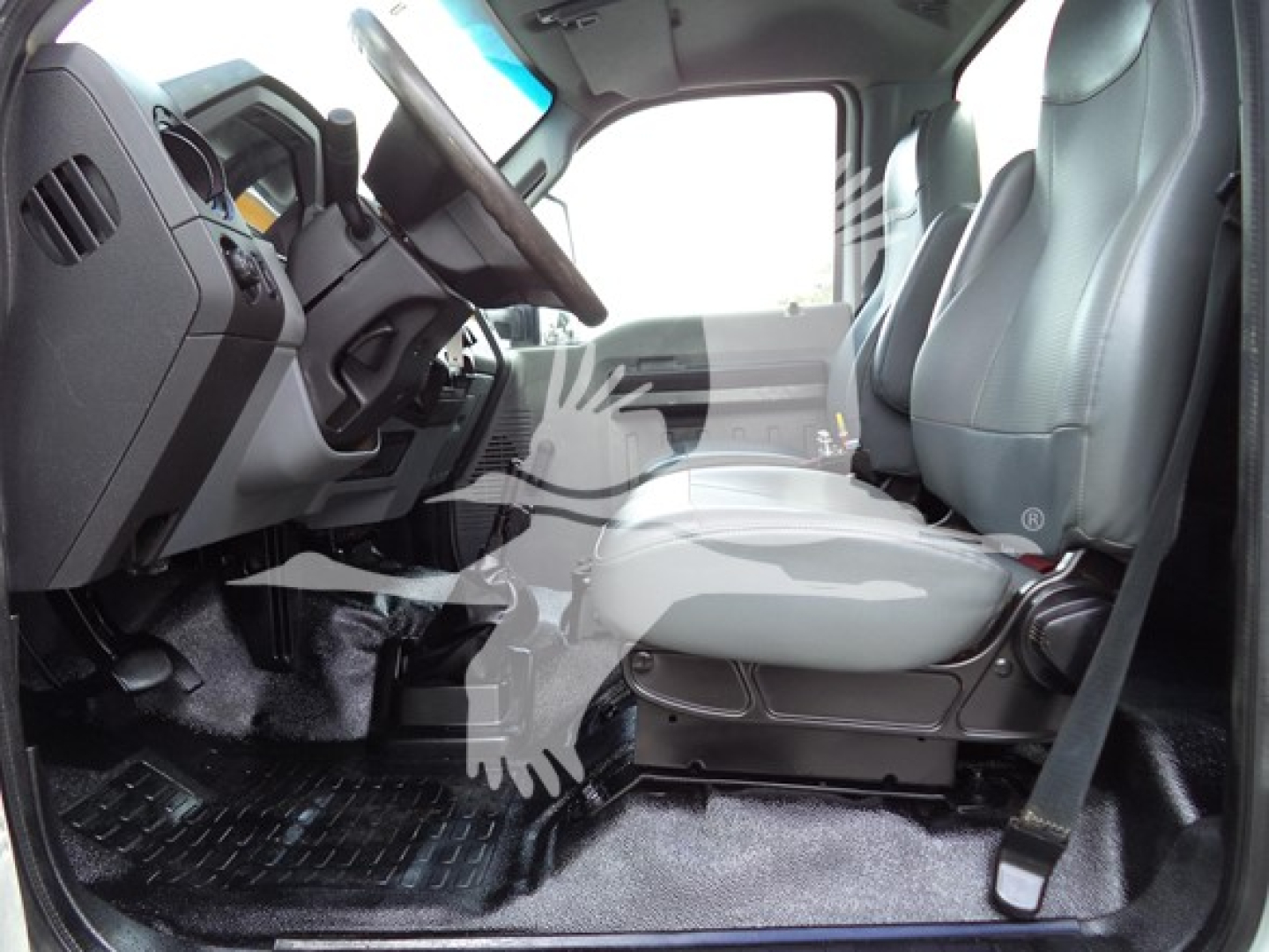 Ford F-Series cab interior showing front seats and dashboard of a 2017 Ford F650 truck; visible steering wheel, pedals, and floor mat.