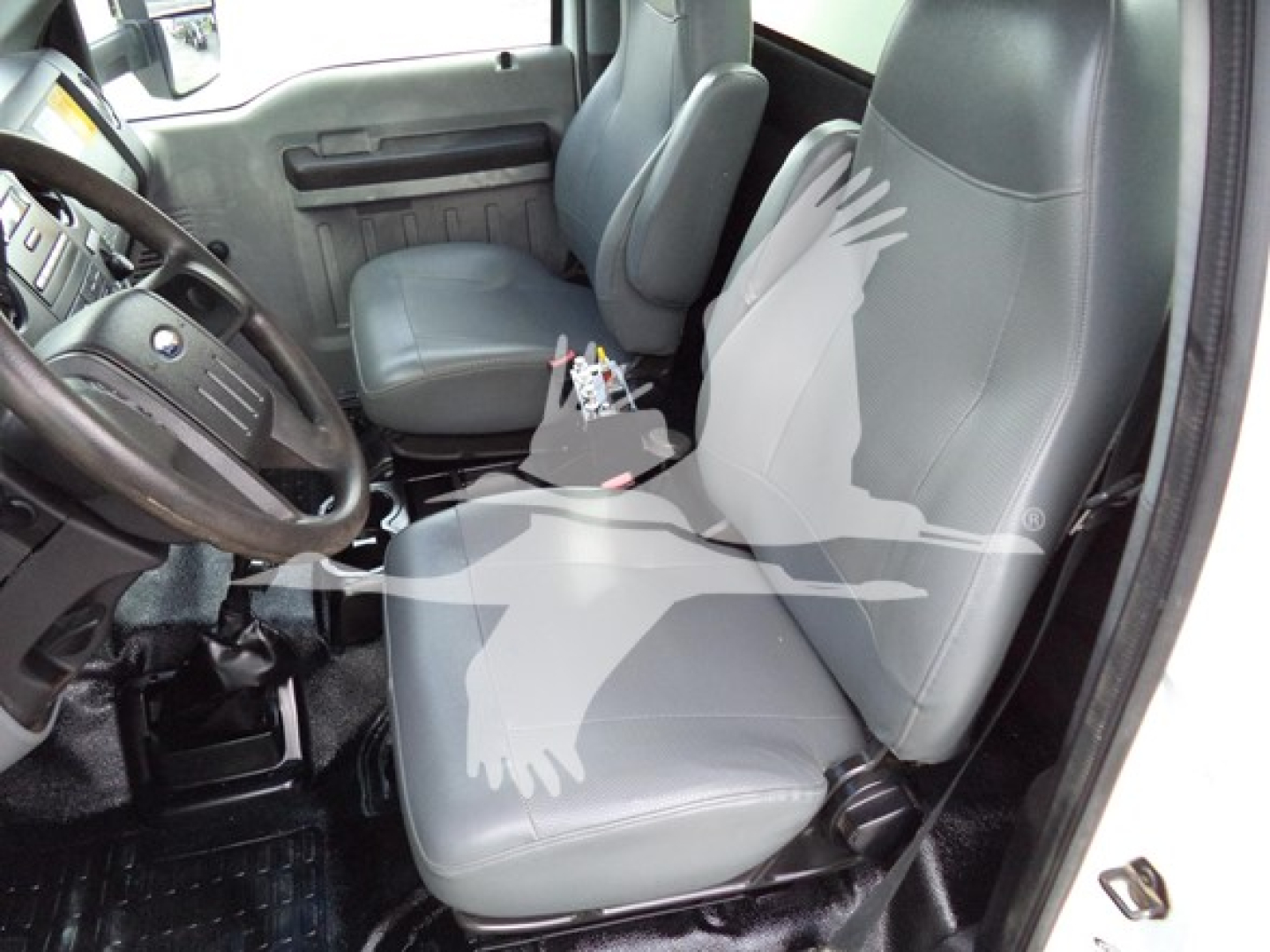 Interior of a 2017 Ford F650 cab showing front driver and passenger seats, steering wheel, and center console with exposed wiring.