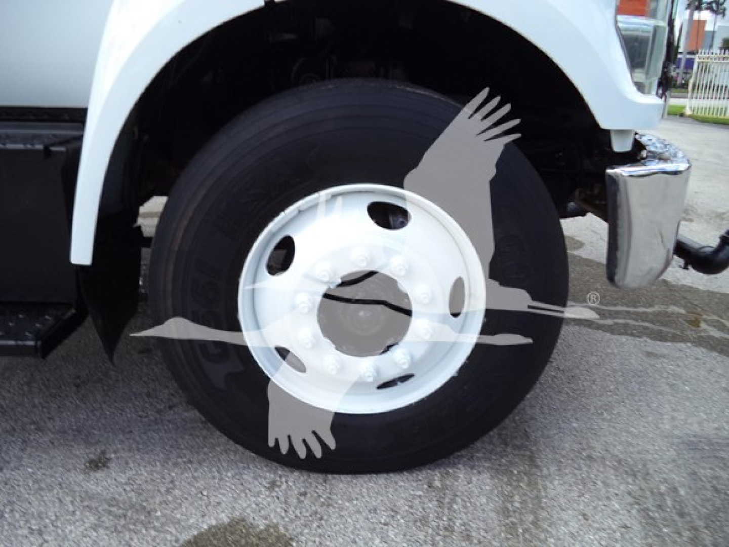 Wheel assembly and front fender of a 2017 Ford F650 truck showing a white steel wheel and tire with chrome bumper nearby.