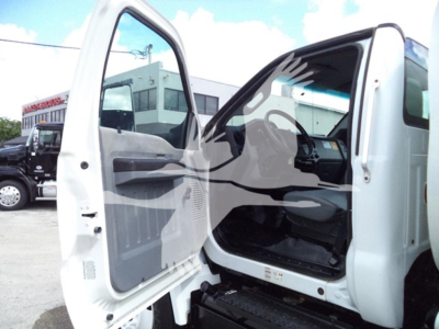 Truck cab with open driver door of a 2017 Ford F650 showing interior, steering wheel, and grey door panel.