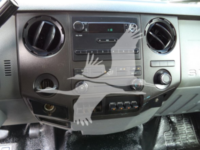 Dashboard of a 2017 Ford F650 interior showing center console with radio, climate controls, two circular air vents, and various switches.