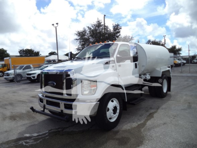 Ford F650 heavy-duty truck with tank body showing front grille, bumper, and water tank on chassis.