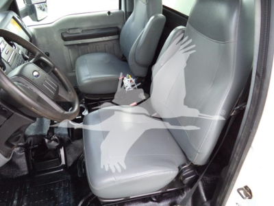 Interior of a 2017 Ford F650 cab showing front driver and passenger seats, steering wheel, and center console with exposed wiring.