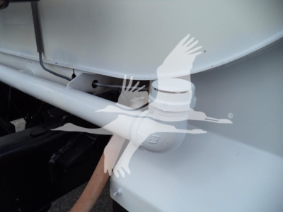 Ford F650 truck hitch area showing chassis tubing and shoulder-mounted tank with a white logo overlay of flying birds