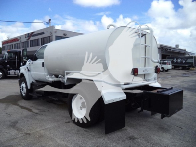Ford F650 rear side view with large white cylindrical tank mounted on chassis and black toolbox at rear.