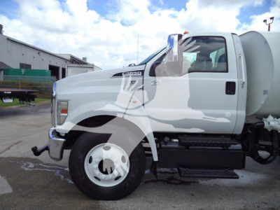 Ford F-650 truck side view showing front fender badge and side step; no legible model or text readable due to reflections and watermark.
