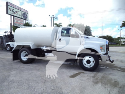 2017 Ford F650 white water tank truck side view showing tank mounted behind cab, single rear axle, front grille, and fuel/air equipment visible.