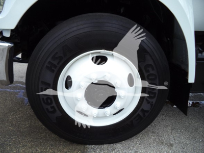 Front wheel of a Ford F650, showing a black tire with a white wheel, no visible brand text on tire ring 