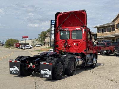 Rear three-quarter view of a red Freightliner Cascadia 116 day cab tractor with open hood/under-hood visible, showing the chassis, dual rear axles, and mudflaps with Kordell signage.