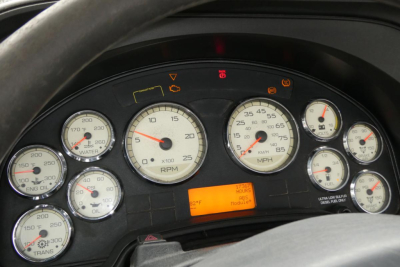 Dashboard of a 2013 International PROSTAR+ 113 truck showing multiple gauges and warning lights.