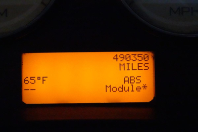 Instrument cluster display showing 490350 miles, ABS module, 65°F ambient, and dash indicators.