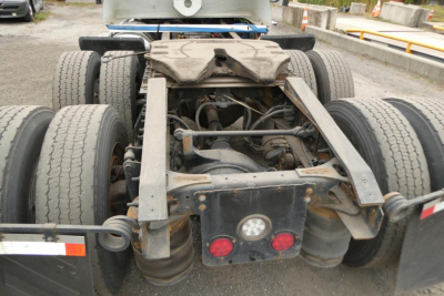 International ProStar+ 113 rear chassis showing suspension, fifth wheel mounting, and dual rear axles with tires.