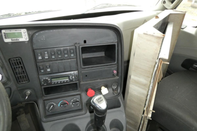 Dashboard and center console of a 2013 International ProStar+ daycab showing gear shifter, ignition area, and control panels.