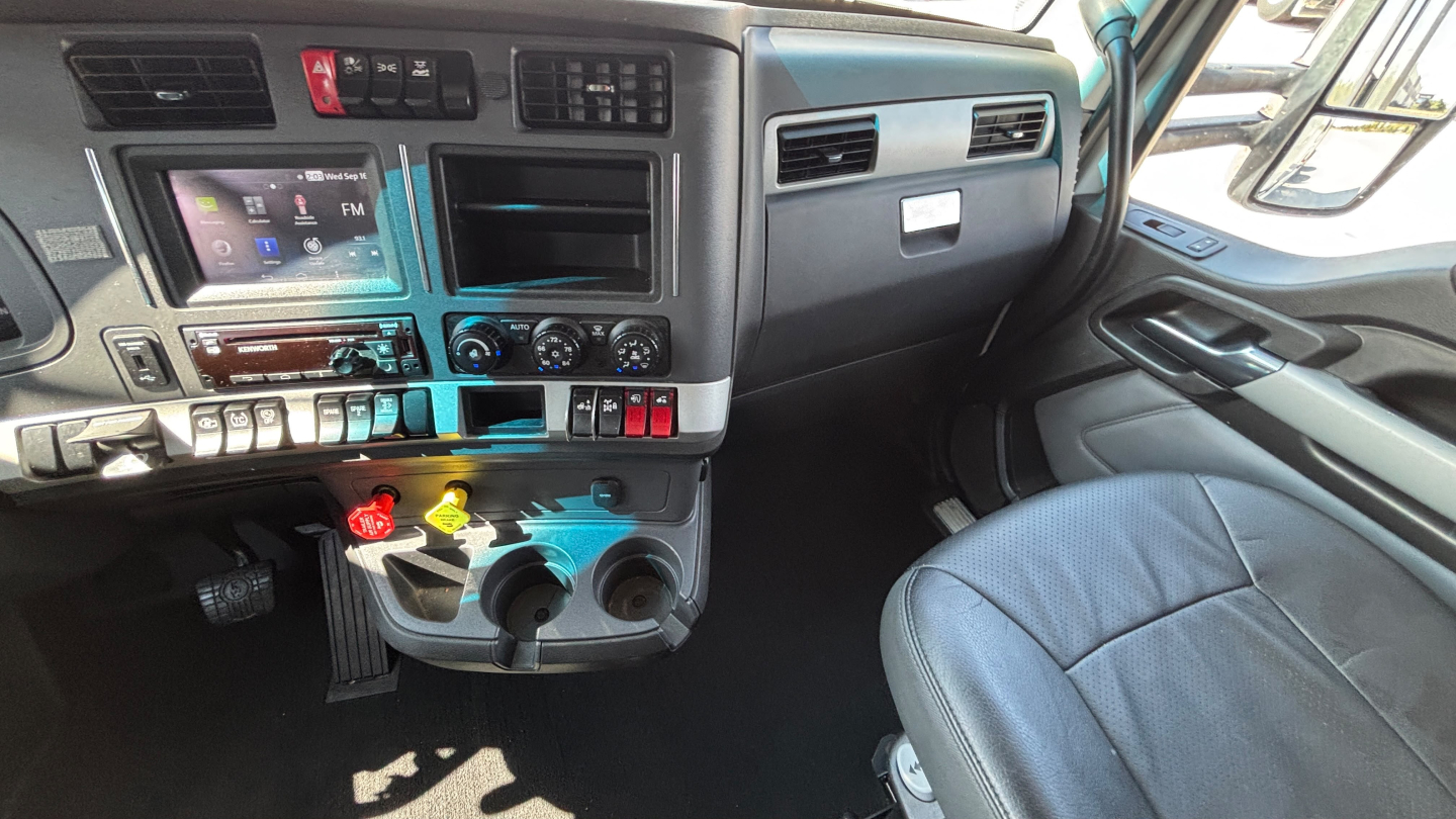 Kenworth T680 truck interior dashboard view showing center console and driver seat.