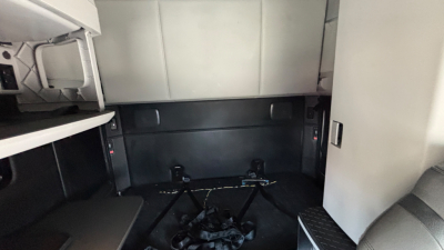 Kenworth T680 interior cargo area with bunk bed storage and mounting brackets in view.