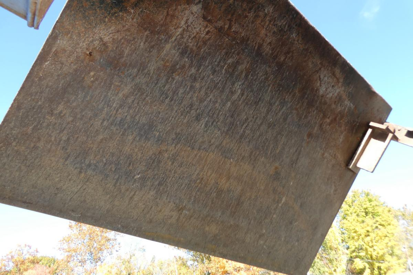 Mack RD688S dump truck bed/spill panel showing metal surface with hinge and latch details.