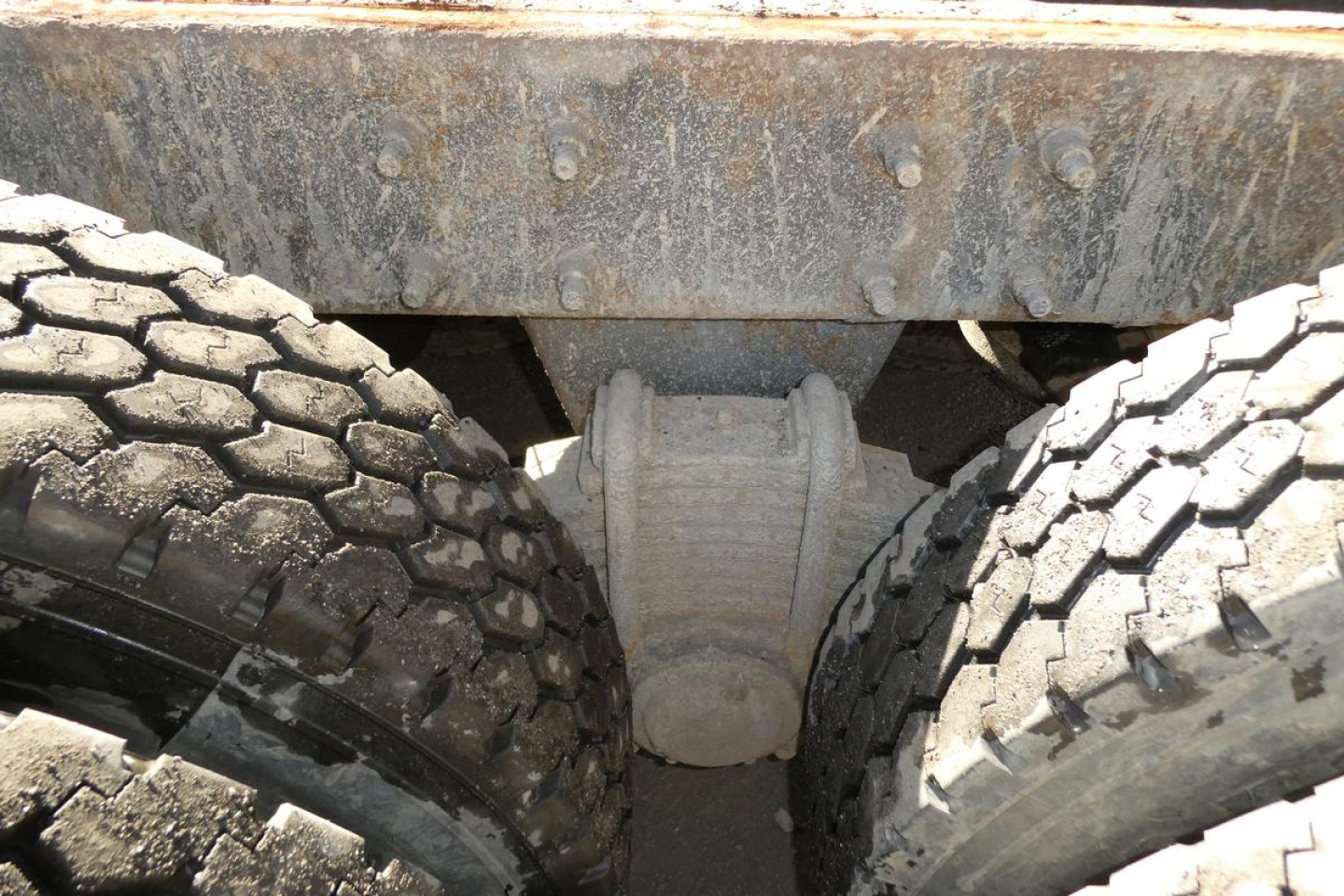 Mack RD688S dump truck undercarriage showing tandem rear axles and differential housing