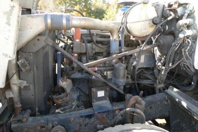 Mack RD688S engine bay showing radiator, hoses, and hydraulic lines with various components.