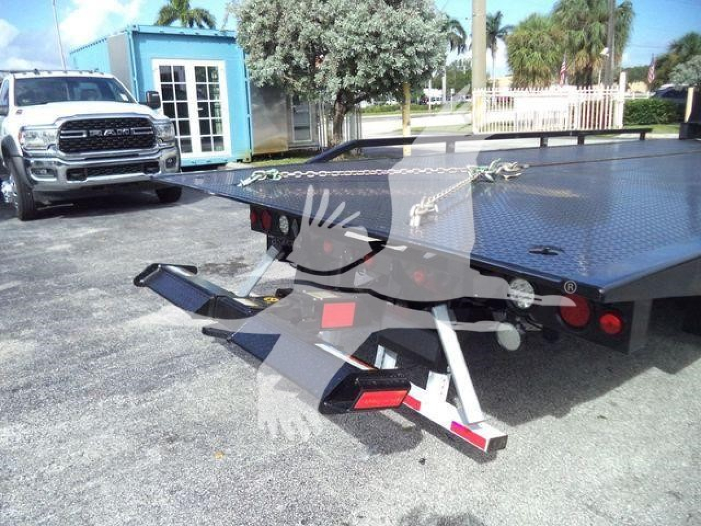 Truck rollback bed with hydraulic wheel-lift attachment showing metal platform and hitch, Chevrolet Silverado 6500HD-related.