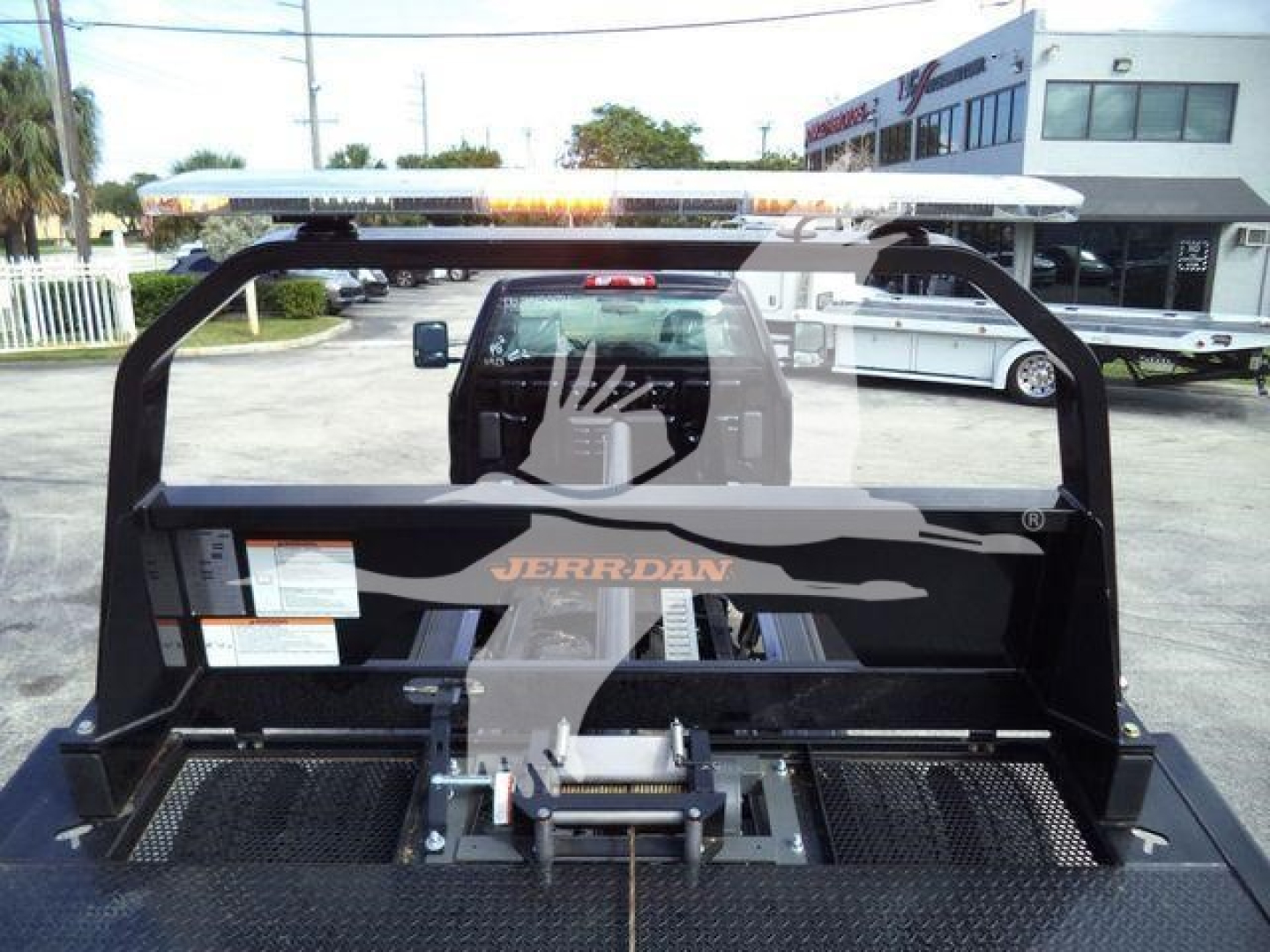 Rear view of a Chevrolet Silverado 6500HD rollback truck with JERR-DAN equipment and a hydraulic winch assembly in the bed.