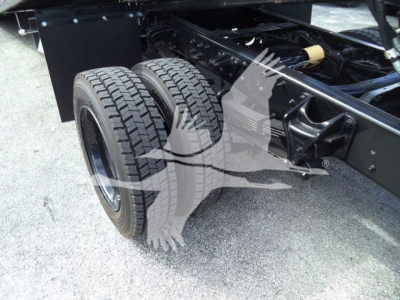 Dual rear wheels and truck chassis showing suspension, leaf springs, and frame on a Chevrolet Silverado 6500HD rollback truck.