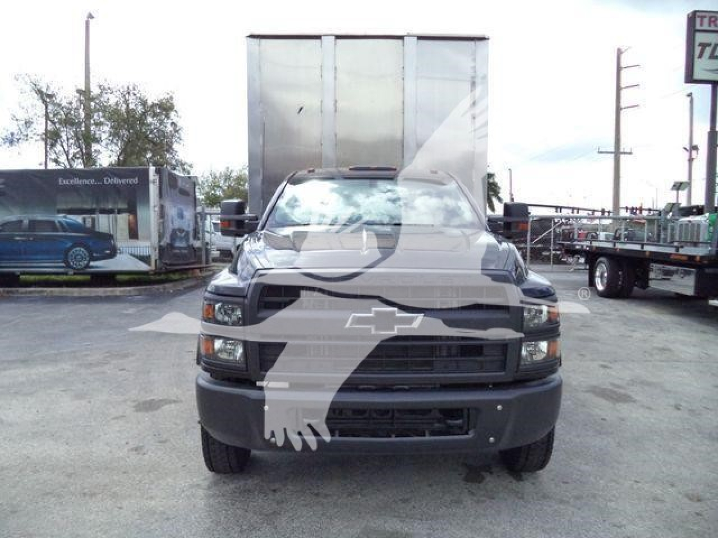 Front view of a 2023 Chevrolet Silverado 6500HD chassis with gray grille and bumper, stock number 16FTCHIP6500HD, in a dealership lot.