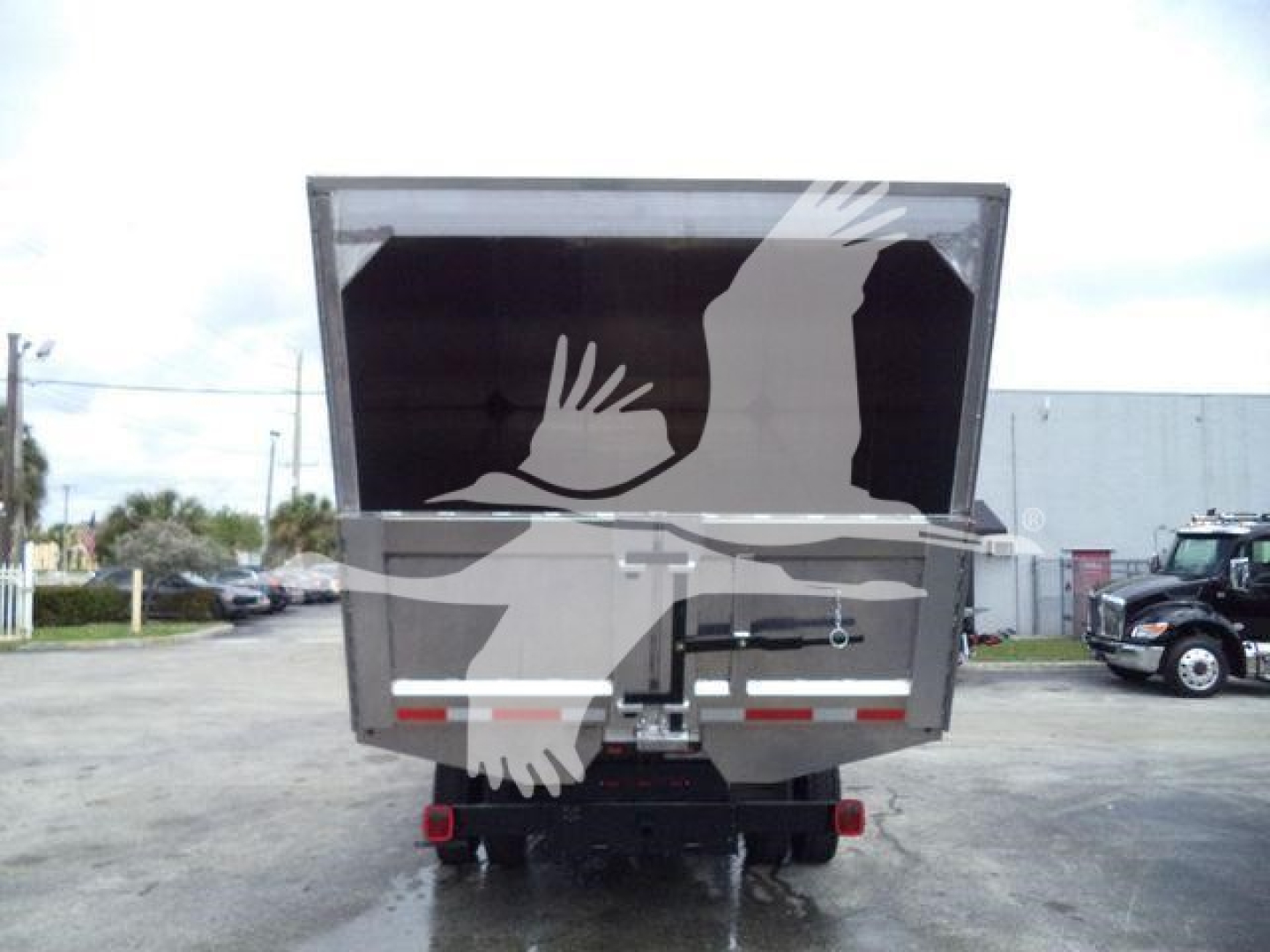 Truck rear showing dump bed and bumper with taillights and hydraulic area, Silverado 6500HD.