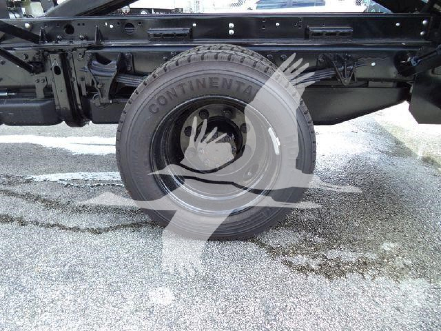 Truck chassis with rear wheel and suspension visible; Continental tire label on wheel.
