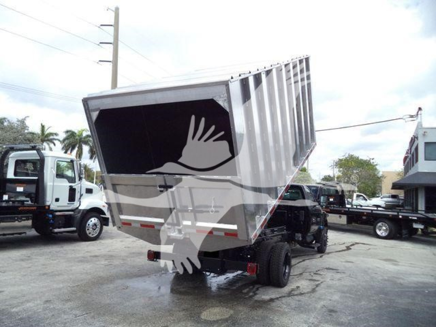 Truck bed tilted dump body showing empty cargo bed and rear lights.