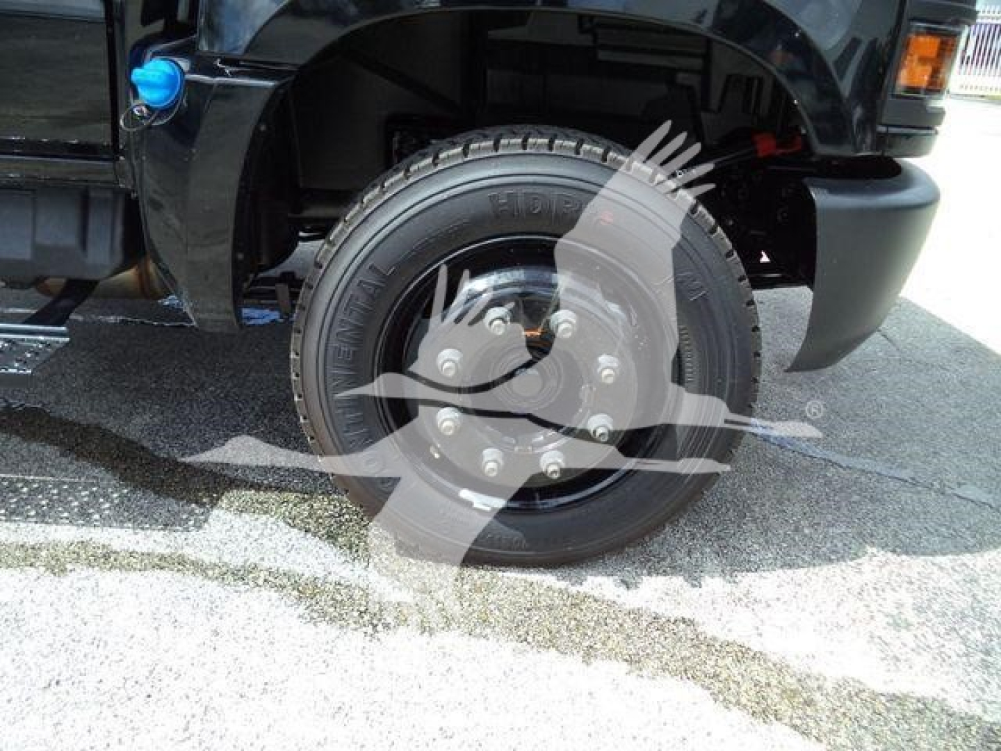 Front wheel and tire of a 2023 Chevrolet Silverado 6500HD with visible wheel hub caps and tire markings in a truck chassis photo.