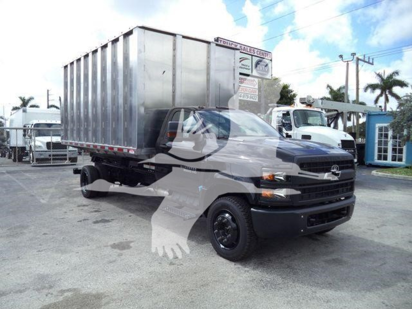 Chevrolet Silverado 6500HD single-cab truck with a steel dump bed in a dealership lot; front view visible