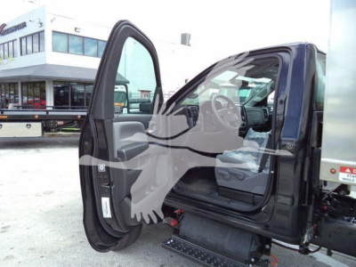Vehicle cab interior with open driver door on a 2023 Chevrolet Silverado 6500HD; visible steps under the door