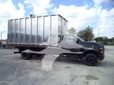 Chevrolet Silverado 6500HD dump truck side view showing large cargo box and cab in black with chrome bumper