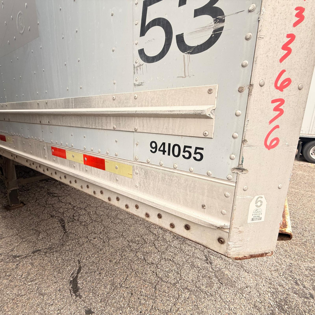 Rear corner of a silver 2008 Great Dane 7441 SL dry van trailer showing wheel area, black numbering 53, serial 941055, and side scalloped edge with rivets.