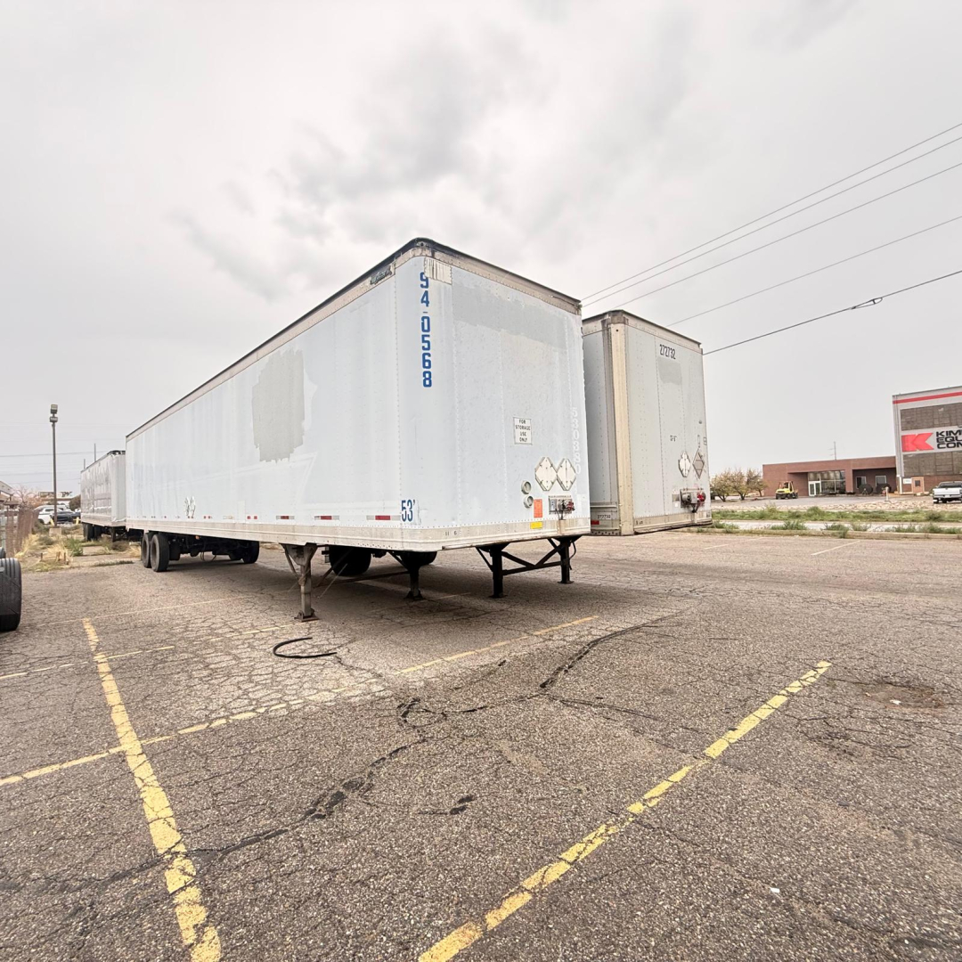Great Dane dry van trailer in a lot, blue exterior with serial/ID numbers on front corner and reflective markings visible.