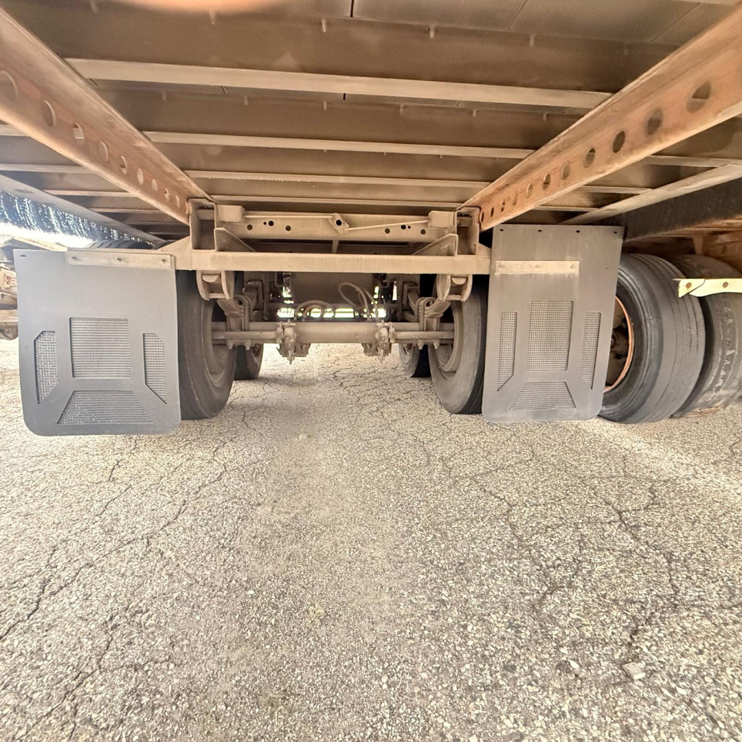 Underbelly view of a Great Dane dry van trailer showing dual rear wheels and undercarriage components with mud flaps on both sides.