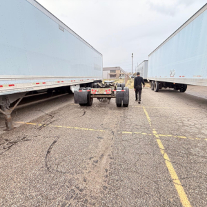 Trailer hitch between two light blue Great Dane 7441 SL dry van trailers in a parking lot.