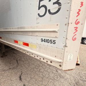 Rear corner of a silver 2008 Great Dane 7441 SL dry van trailer showing wheel area, black numbering 53, serial 941055, and side scalloped edge with rivets.