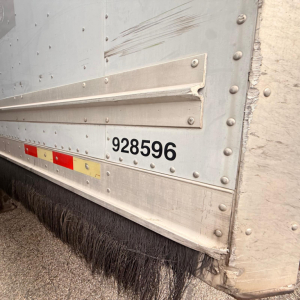 Trailer side panel showing gate with number 928596 and curtain side edge, Great Dane 7441 SL trailer.