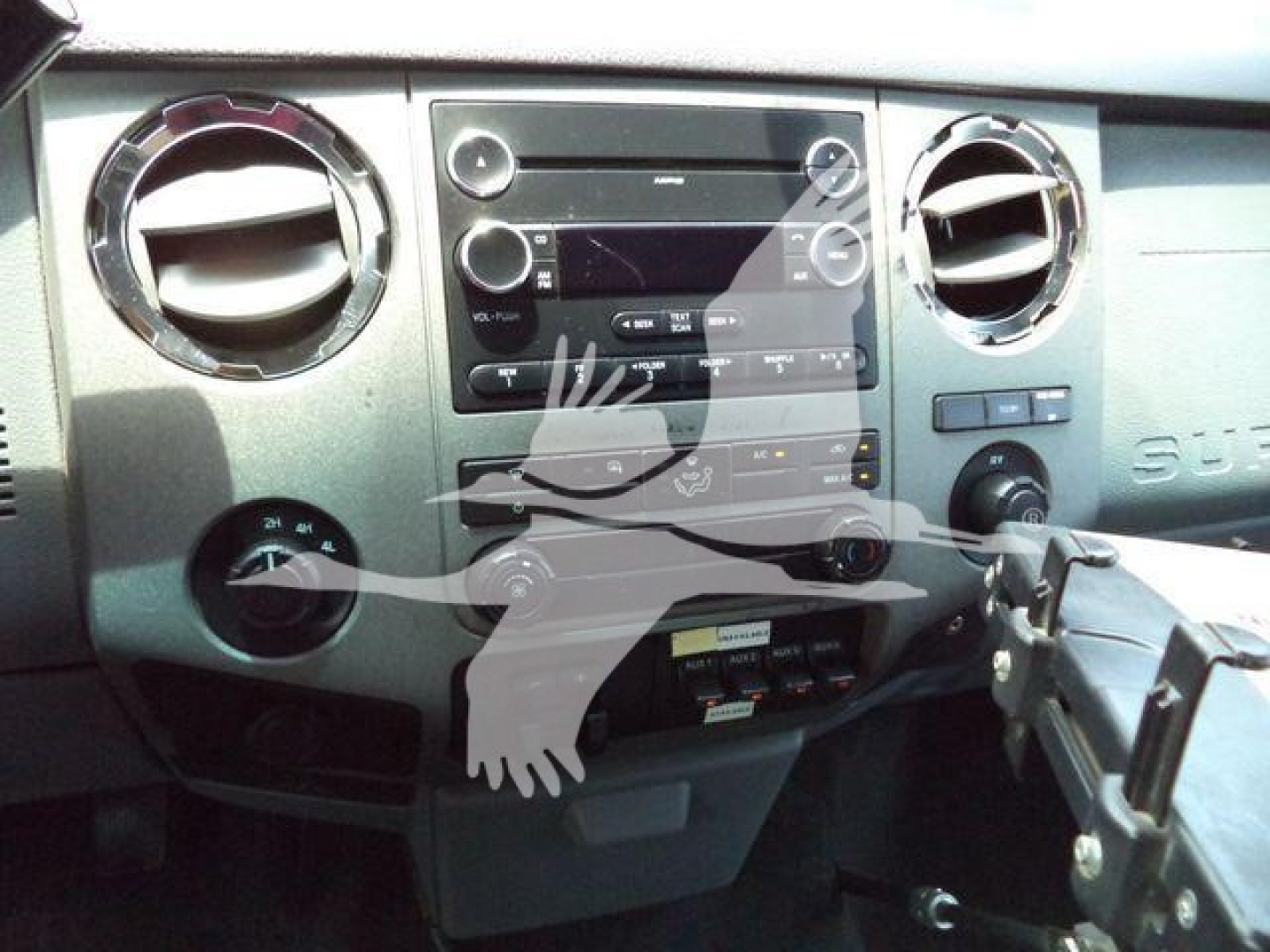 Ford F-450 dashboard and center console with radio, climate controls, and gear selector visible.