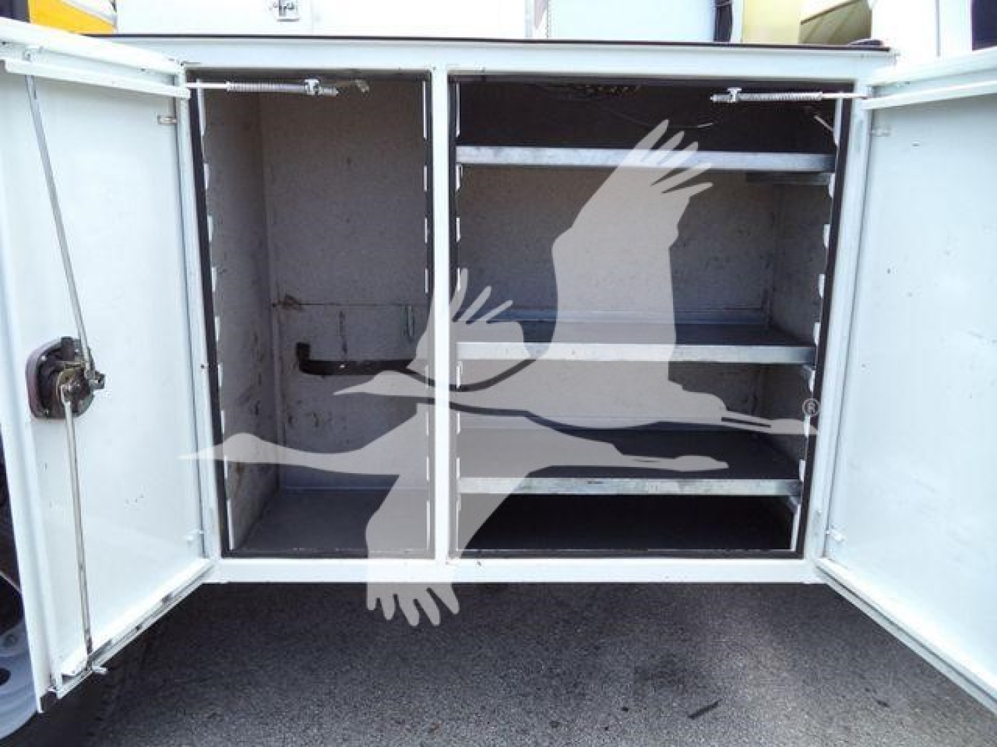 Service/Utility truck cargo area with open rear compartments showing shelves and storage space.