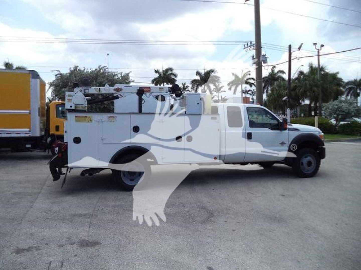 Ford F-450 service utility truck in profile with multiple compartments and equipment rack, no visible text legible