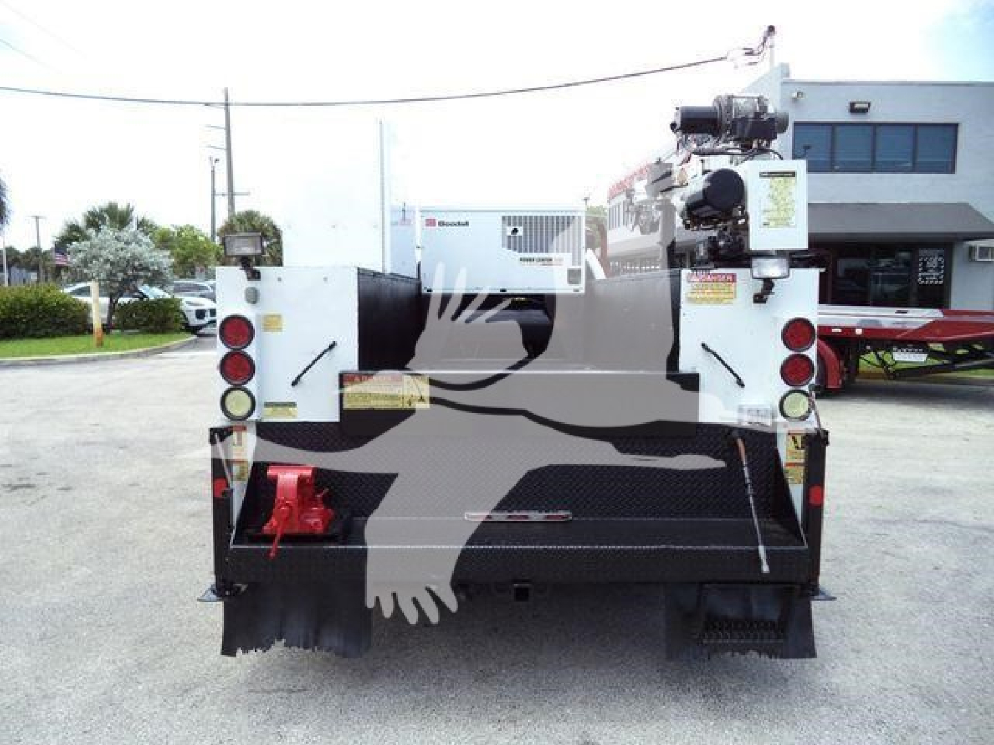 Rear view of a Ford F-450 service/utility truck with crane and equipment mounts, tail lights, and bumper.